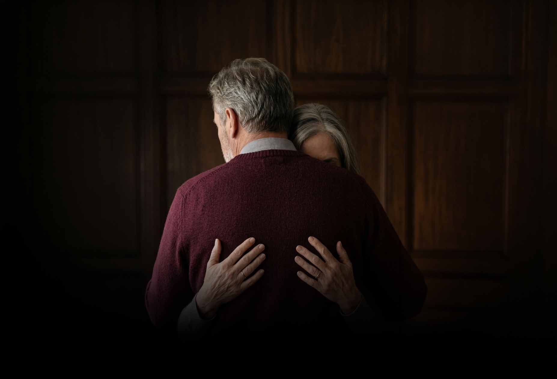 An older couple embracing